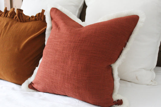 Terracotta fringed cream trim cotton cushion 45 x 45cm
