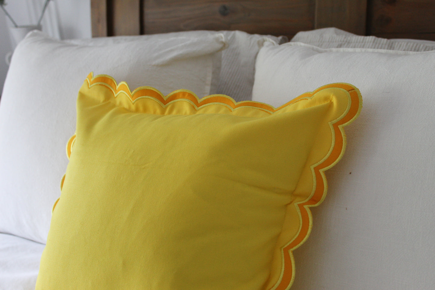 Yellow scalloped edge cushion