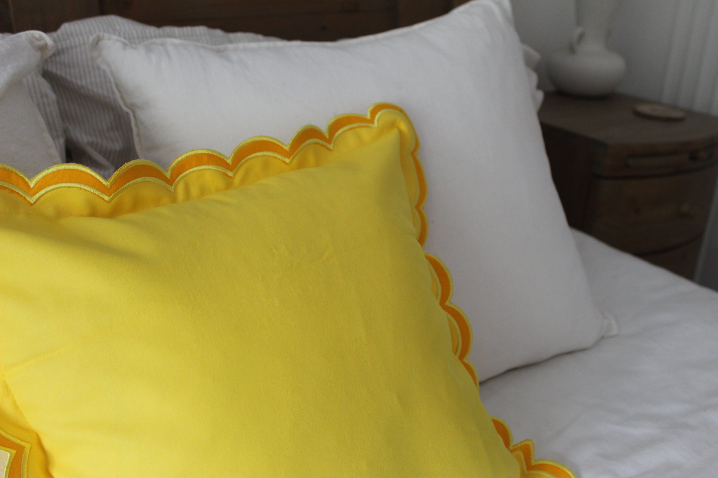 Yellow scalloped edge cushion