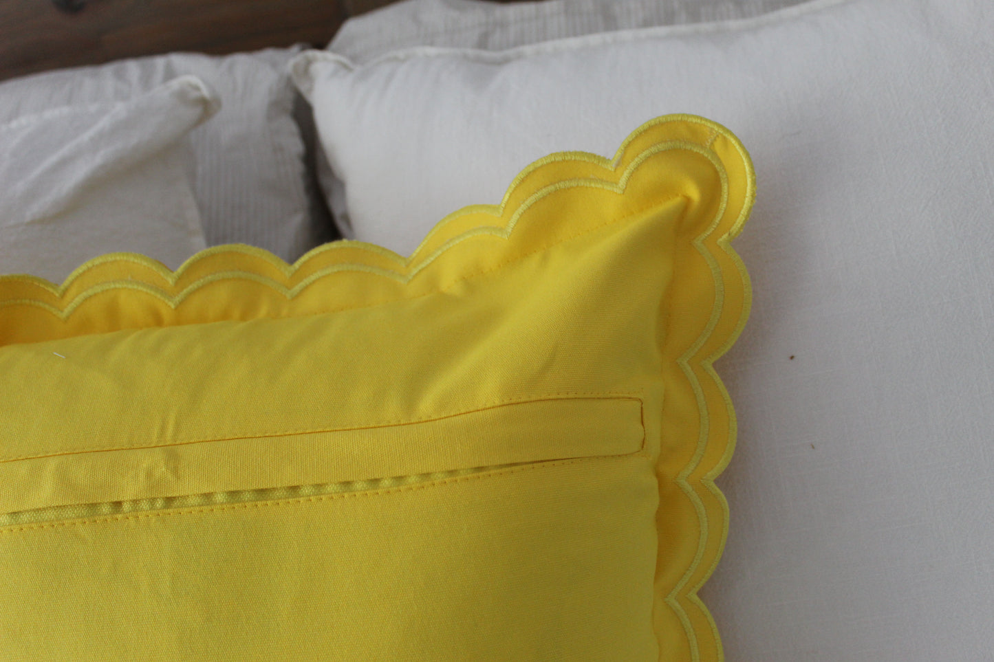Yellow scalloped edge cushion