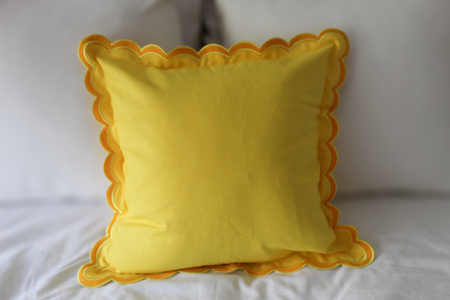 Yellow scalloped edge cushion