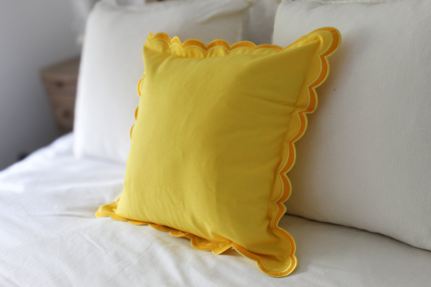 Yellow scalloped edge cushion