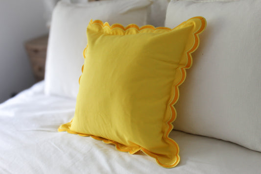 Yellow scalloped edge cushion