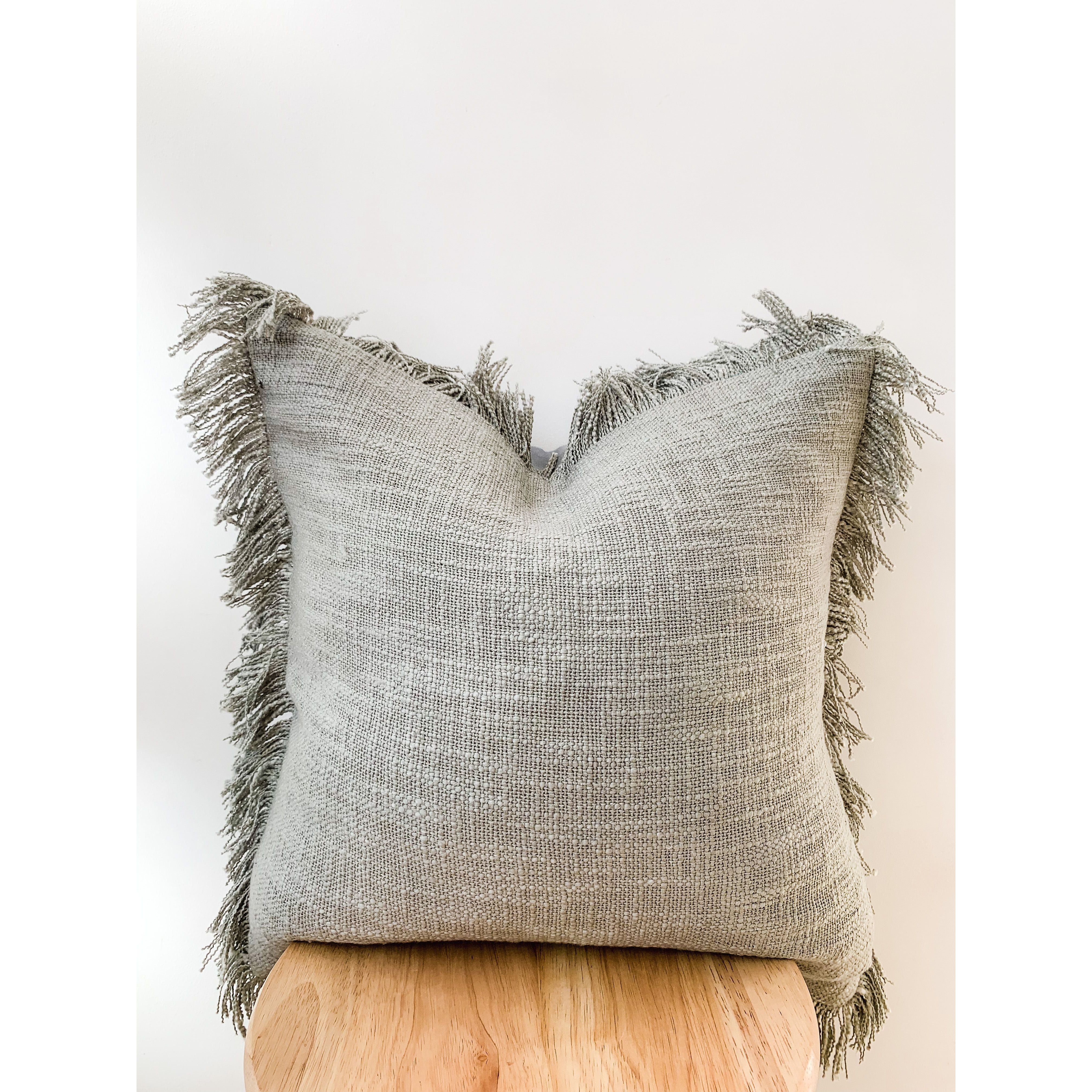 Grey fringe shop cushion